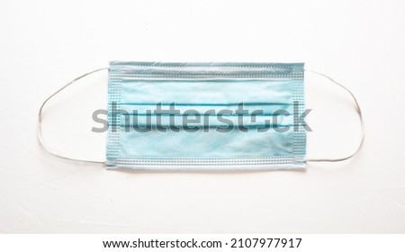 Medical mask isolated on white background. Surgical mask with rubber ear straps for mouth and nose cover. 