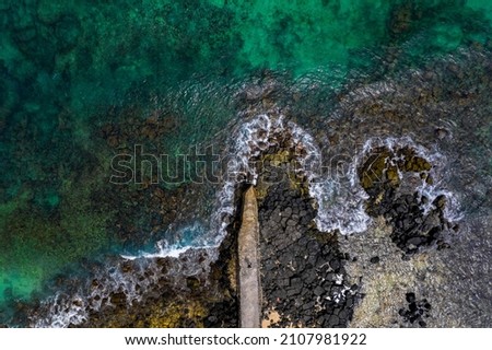 Aerial view of a fishing pier and the waves crashing on the south coast of Mauritius island
