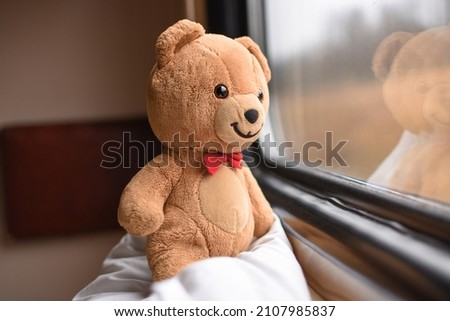 teddy bear rides in a train on a journey. Adventure. Story. Positive. Railway. Childhood. Lifestyle. copy space. Royalty-Free Stock Photo #2107985837