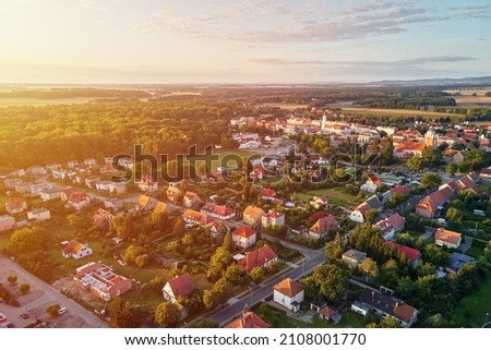 Aerial view of suburban neighborhood, Residential district with buildings and streets at small european town at sunset Royalty-Free Stock Photo #2108001770