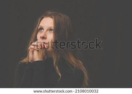 Young woman praying  to God. Christian life crisis prayer to god. Royalty-Free Stock Photo #2108010032