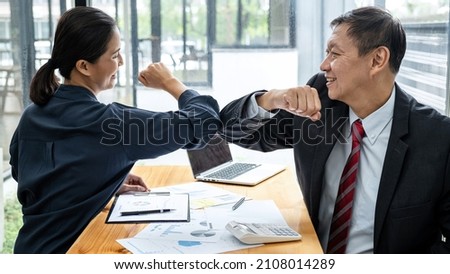 Business team is shaking with elbow bump in new normal concept to greeting when meeting in office for protection from covid-19