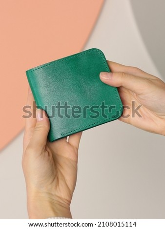 green leather purse closeup photo in human hand
