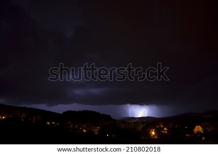 small lightning panorama at night above village