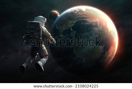 Astronaut at spacewalk looks at Earth planet. Elements of image provided by Nasa