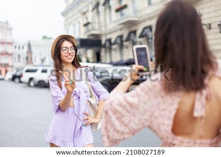 Two young stylish women friend having fun together, taking pictures in the city. Lifestyle. Travel concept