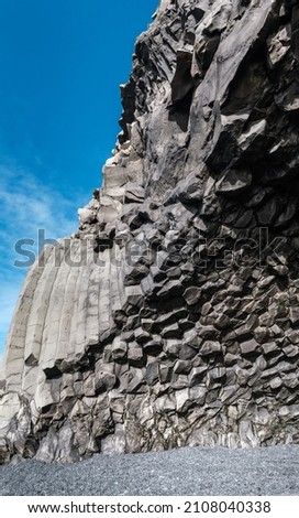 Basalt rock pillars columns at Reynisfjara beach near Vik, South Iceland. Unique geological volcanic formations. Сave at the foot of the Reynisfjall mount. High resolution stitch image.