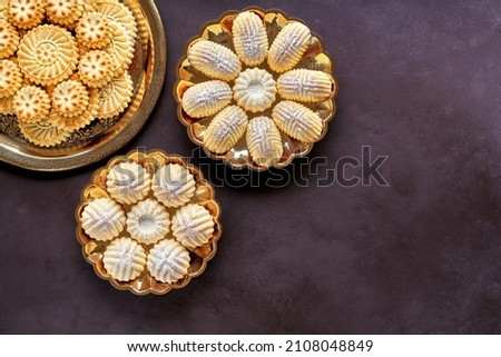  Assorted semolina maamoul or mamoul cookies with dates , walnuts and pistachio nuts. Traditional arabic Eid al Adha, Eid al Fitr sweets   . Top view, copy space                           Royalty-Free Stock Photo #2108048849