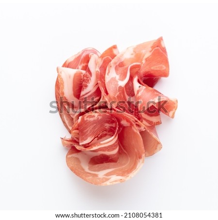 Italian prosciutto crudo. Jerked ham, isolated on white background. Royalty-Free Stock Photo #2108054381