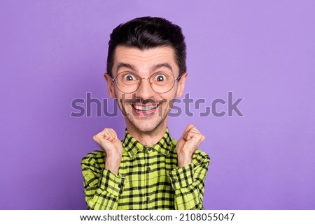 Photo of cheerful caricatured guy two raised fists celebrating isolated on violet colored background Royalty-Free Stock Photo #2108055047