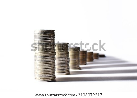 stacks of coins from largest to smallest in perspective and shadows on a white background. High quality photo