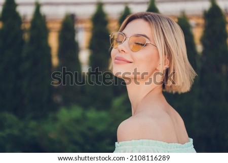 Profile side photo of young attractive girl happy positive smile dream enjoy walk park nature eyeglasses outdoors