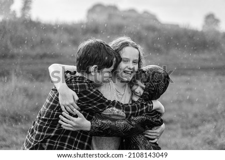 Black and white portrait. Children smile hugging outdoors. Friendship concept. Royalty-Free Stock Photo #2108143049