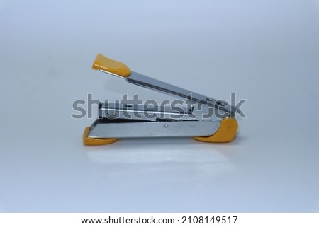 yellow stapler on a white background    