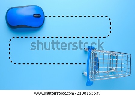 A picture of cart with blue mouse and dash line. Online shopping concept.