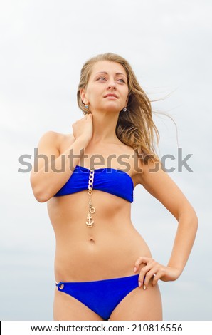Pretty woman posing near the sea.