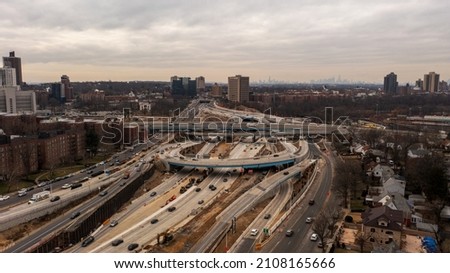 Aerial top view photo over highway with multilevel junction, paved roads in urban populated area of Queens, New York.