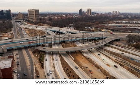 Aerial top view photo over highway with multilevel junction, paved roads in urban populated area of Queens, New York.