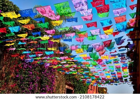 street with mexican decoration of color with paper in the street of san miguel de allende guanajuato   Royalty-Free Stock Photo #2108178422