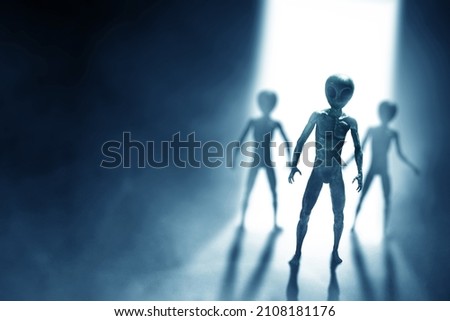 Silhouettes of aliens creature on dark background Royalty-Free Stock Photo #2108181176