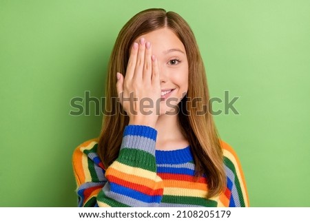 Portrait of attractive funny girly cheerful girl closing one eye checking sight isolated over bright green color background