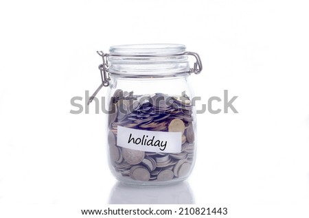 Glass jars with coins and 'holiday' text