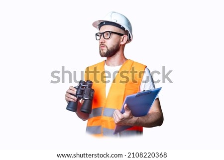 Young man in building clothes, with binoculars, with a clipboard on a light background