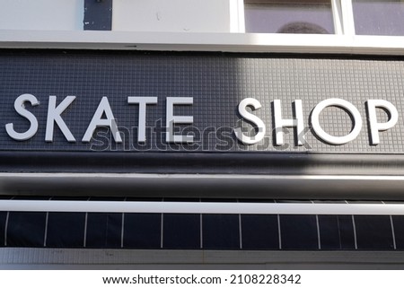 skate shop text sign facade store logo in city street specialized in skateboard