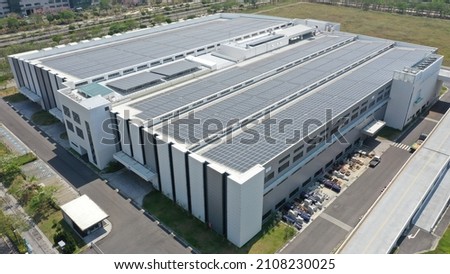 Modern factory building with roof mounted solar system Royalty-Free Stock Photo #2108230025