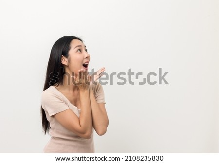 Excited asian woman shout out loud wow with hands on isolated white background. Happy shocked face female wow promotion advertising concept. Joyful teenage girl standing in white room.