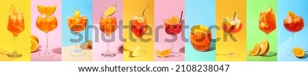 Glasses of tasty Aperol spritz cocktail on color background