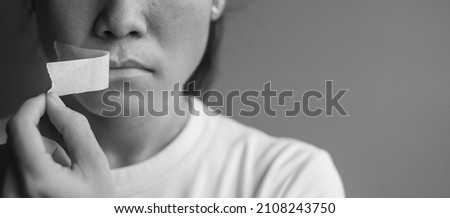 woman with mouth sealed in adhesive tape. Free of speech, freedom of press, Human rights, Protest dictatorship, democracy, liberty, equality and fraternity concepts Royalty-Free Stock Photo #2108243750