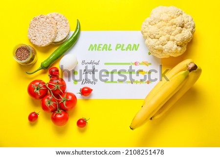 Healthy products and meal plan on yellow background