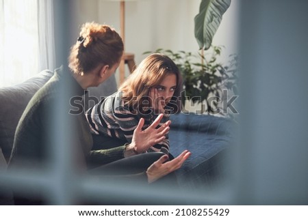 Teenage girl in difficult mood with angry mom. Royalty-Free Stock Photo #2108255429