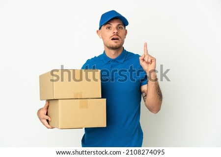 Delivery caucasian man isolated on white background thinking an idea pointing the finger up