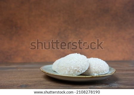 Coconut snowball white truffles on wooden background Royalty-Free Stock Photo #2108278190