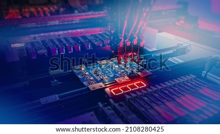 Automatic Electronic production of computer chips by SMT Pick and Place machine with Machine Vision System. Machine Vision System inspect PCB for components size and placement while Chip Production. Royalty-Free Stock Photo #2108280425