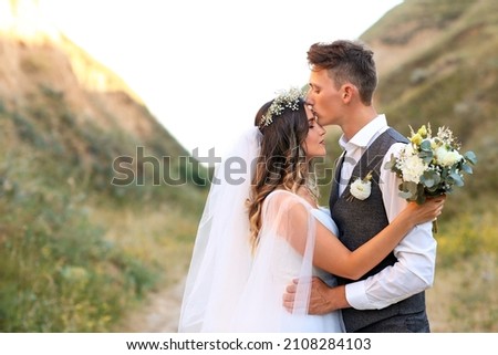 Happy wedding couple in countryside Royalty-Free Stock Photo #2108284103