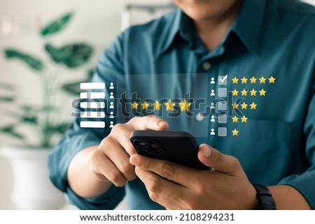 User give rating to service experience on online application, Customer review satisfaction feedback survey concept, Customer can evaluate quality of service leading to reputation ranking of business. Royalty-Free Stock Photo #2108294231