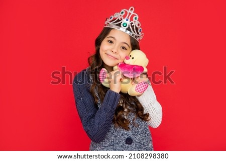 happy lovely child in queen crown. princess in tiara. kid hold bear toy. teen girl
