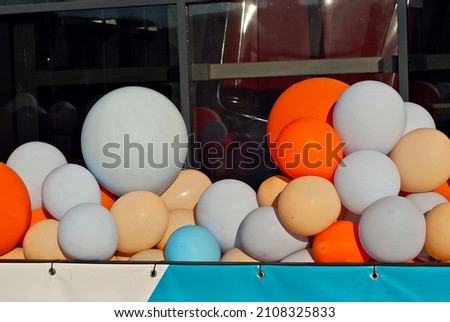 The entrance to the store is decorated with colorful balls. Multicolored balloons close up. Festive opening.