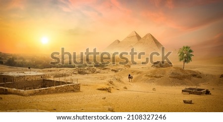 Egyptian pyramid in sand desert and clear sky Royalty-Free Stock Photo #2108327246