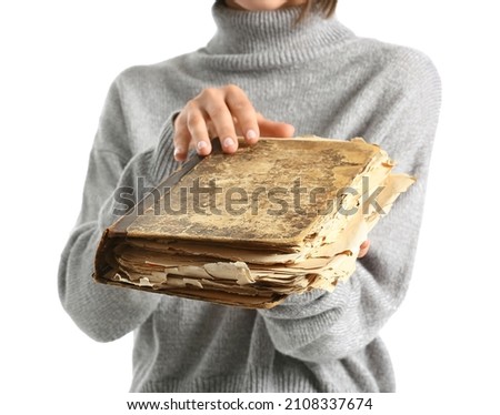 Beautiful woman with old book on white background, closeup