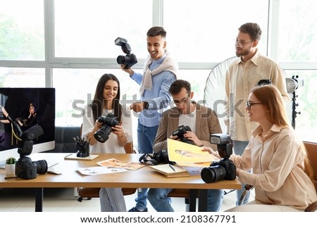 Professional photographer teaching young people in studio