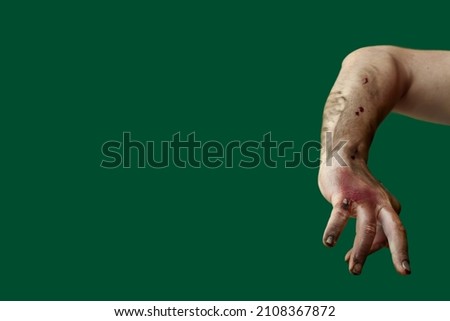 Hand of zombie on color background