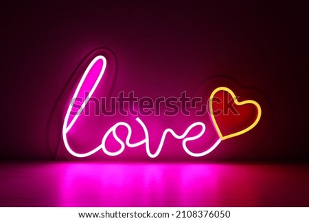 Pink and red neon heart with the inscription love. Valentine day. Neon sign. Custom neon. Home decor. Trendy style. Wedding design.