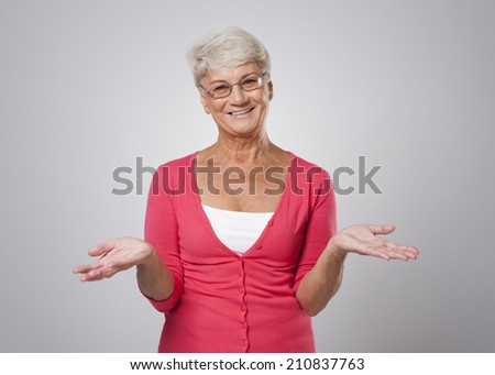 Lovely senior woman with open hands 