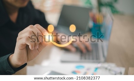 The consumer answered the survey in a conceptual way. Customer creates a happy face smiling symbol using a digital pen. The notion of customer happiness and service experience. Royalty-Free Stock Photo #2108382377