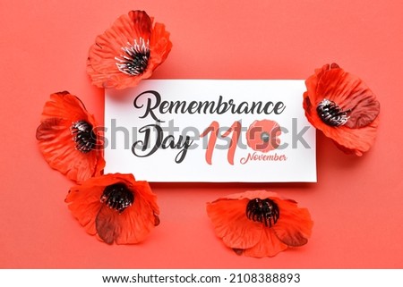 Remembrance Day in Canada. Red poppy flowers with card on red background