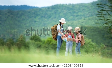 Group family children travel on car for adventure nature in vacations.  Asia people tourism checking map for explore natural destination and leisure trips travel for education.  Travel Concept Royalty-Free Stock Photo #2108400518